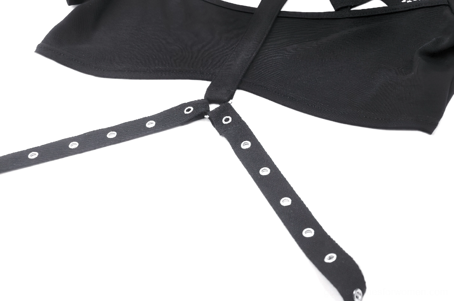 Close-up detail of front cross-over strap harness with metal eyelet hardware