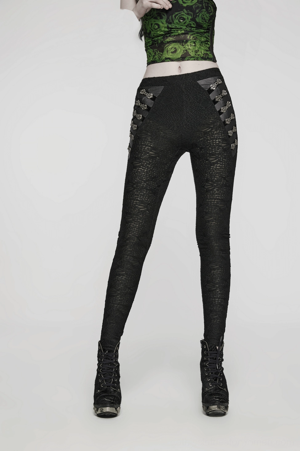 Full-length view of black lace skull gothic leggings showing close-fitting silhouette and metal buckle embellishments