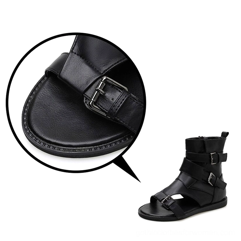 Close-up detail of black gladiator sandal polished metal buckle and smooth PU leather upper material