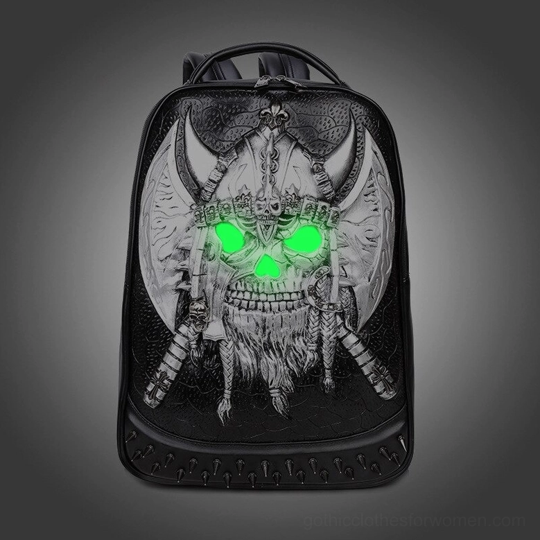 Glowing silver viking skull backpack with luminescent green eyes and dark gradient studio background
