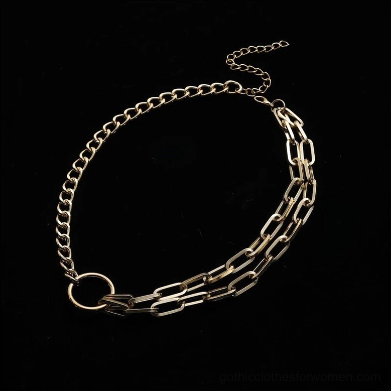Gold tone paperclip chain choker with geometric circle pendant, flat lay detail shot showing chain links and construction