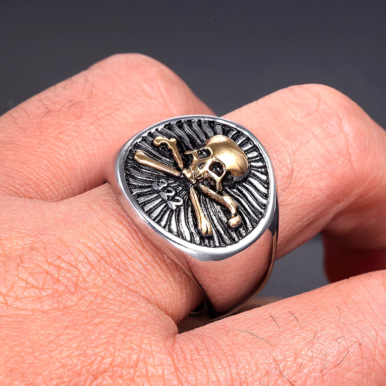 Gold accent skull pirate ring on hand, side close-up showcasing two-tone design and fit