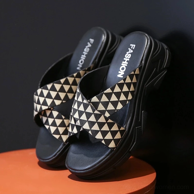 Khaki and black crisscross platform slides with branded insole detail, three-quarter side view against dark studio background