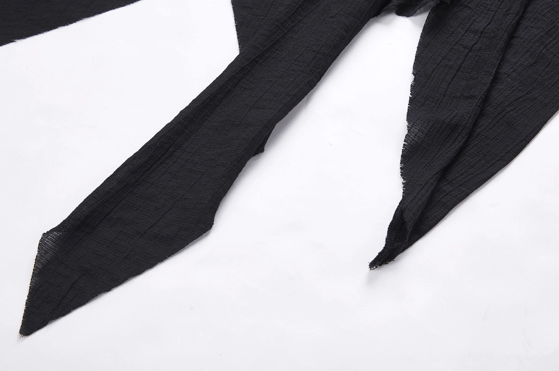 Pointed and uneven cut edges of shredded asymmetrical hemline on black gothic trench coat