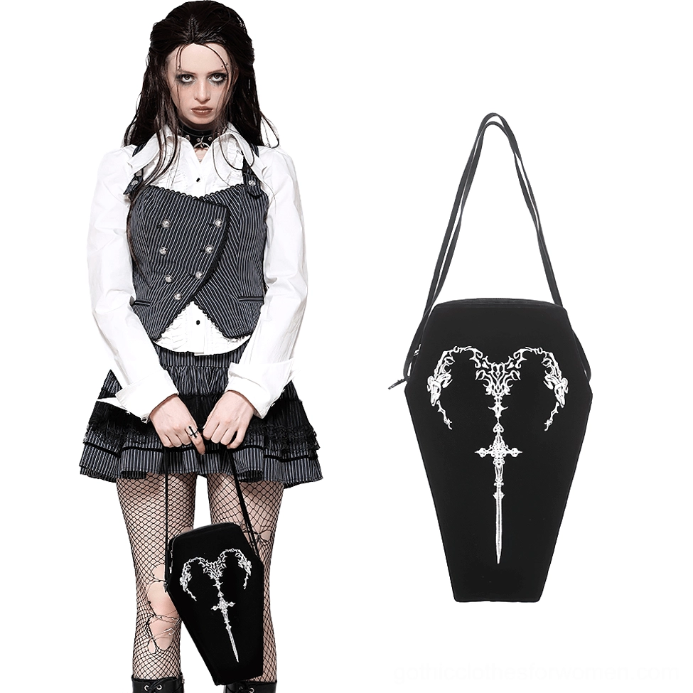 Female goth model in alternative school outfit carrying embroidered coffin shoulder bag