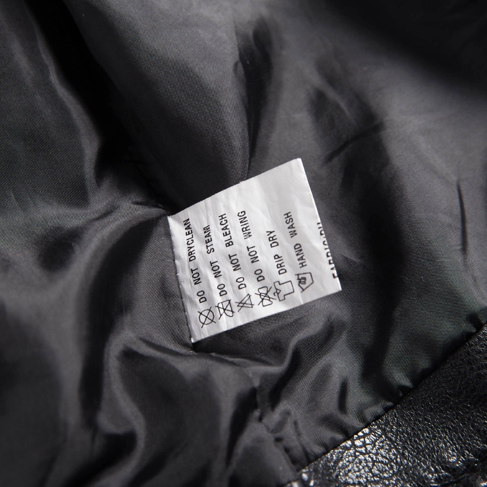 Black motorcycle jacket detailed front view with epaulet shoulder detail zipper accents and stud embellishment
