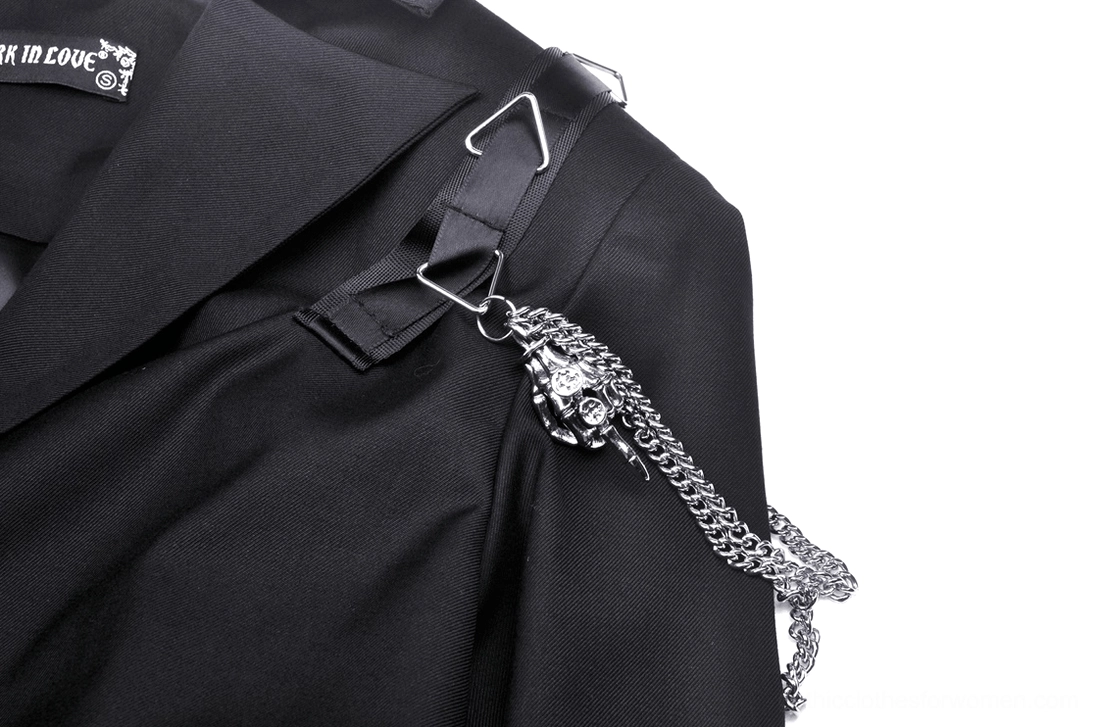 Close-up detail of skull charm and silver metal chain on goth jacket shoulder