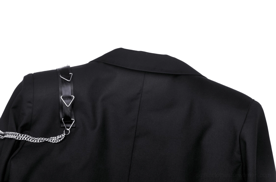 Close-up detail of triangle metal buckle and chain embellishment on back of goth jacket