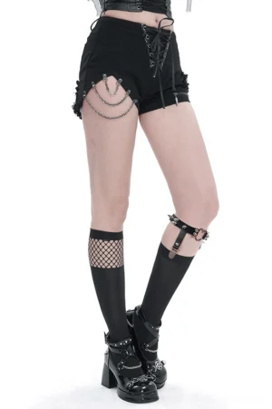 Female model wearing asymmetrical mesh gothic knee-high socks with metal heart garter paired with punk street style outfit and platform boots