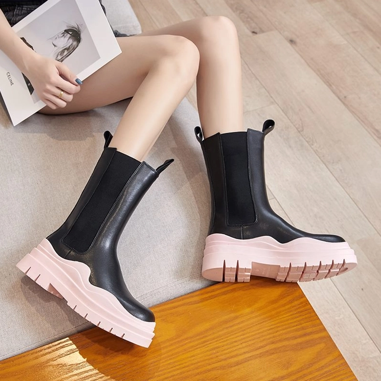 Women wearing black leather chunky platform boots, demonstrating goth subculture aesthetic with modern colored sole options