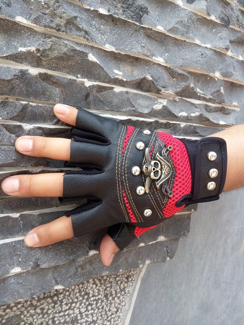 Goth subculture skull rivet fingerless gloves with velcro strap and mesh panels design focus