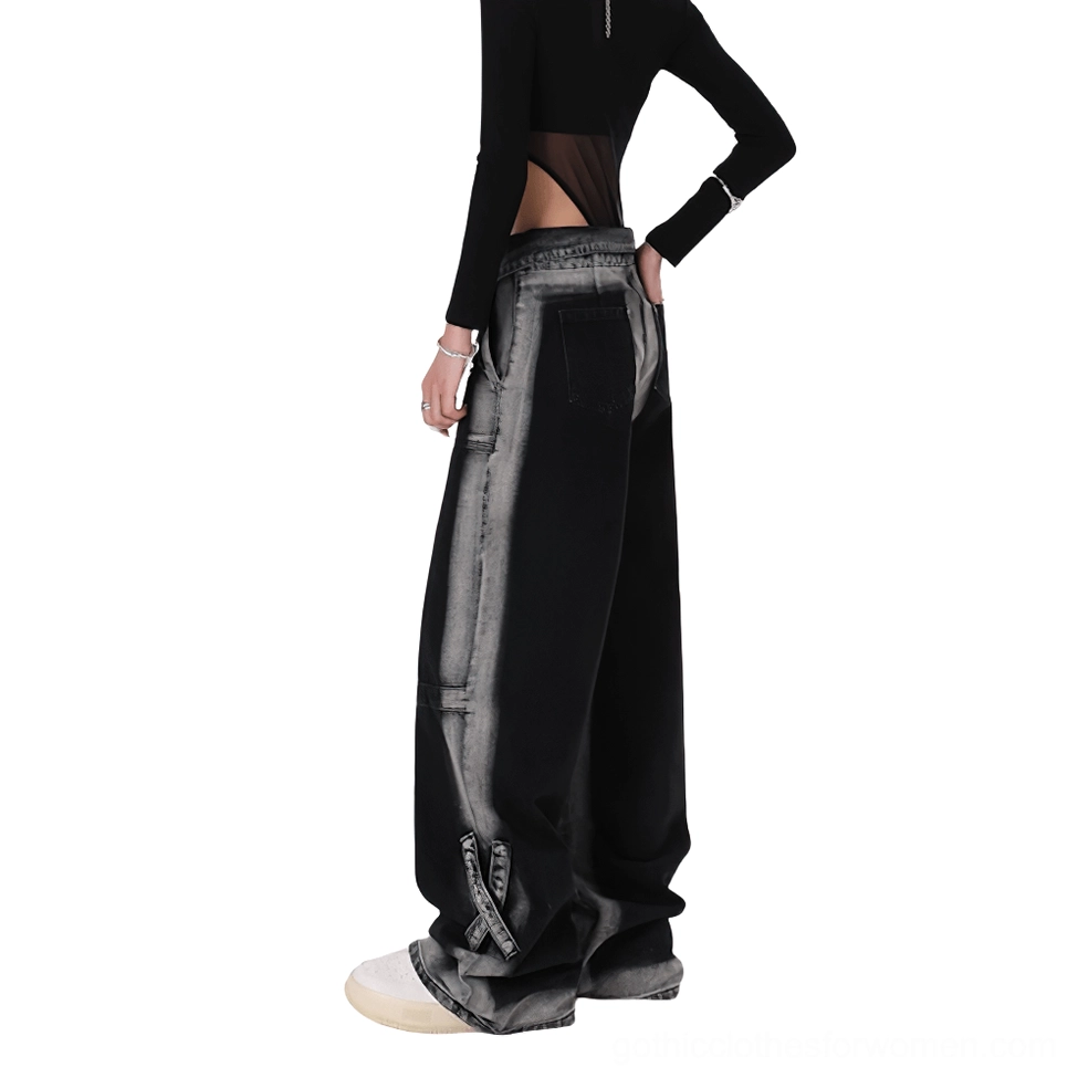 Side back view of black gothic denim jeans with gradient fade wash and leather patch detail