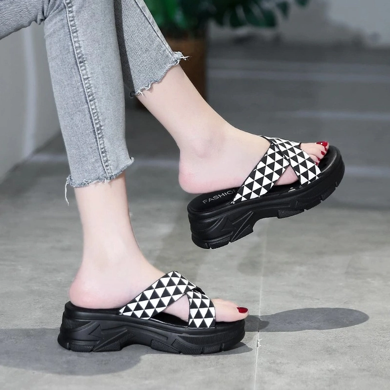 Gothic crisscross platform sandal pair with khaki and black geometric straps, studio product shot highlighting alternative fashion design