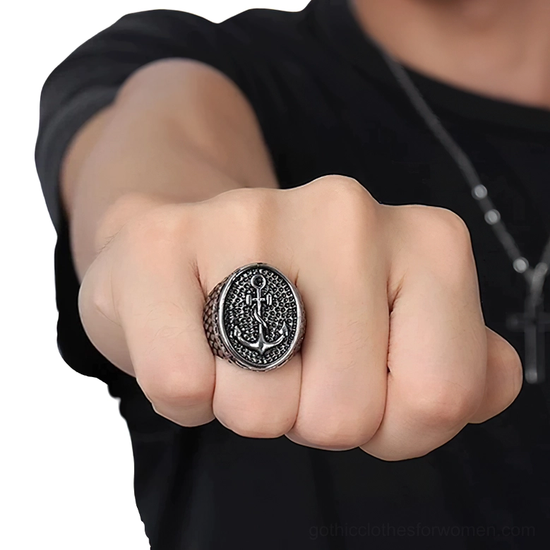 Unisex gothic anchor ring worn on male hand middle finger against black clothing, close-up front view showcasing silver-black vintage tone