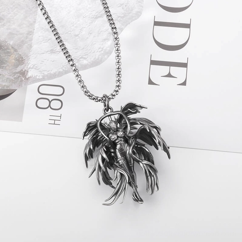 Gothic angel pendant necklace angled flat lay - vintage silver-toned design on decorative paper