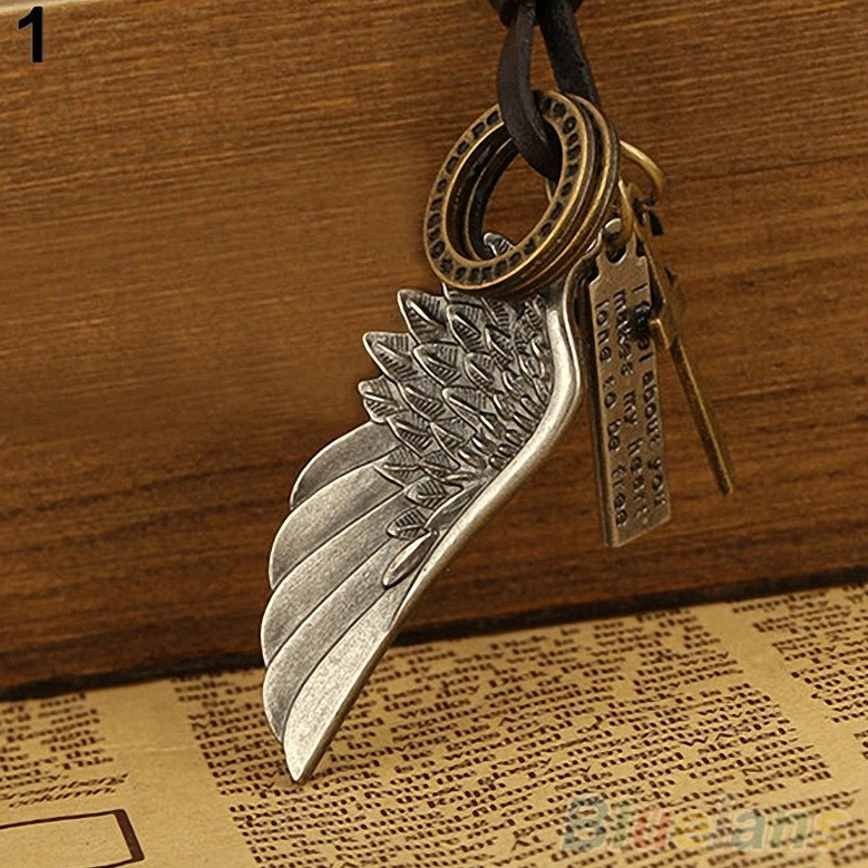 Brown leather adjustable gothic angel wing choker with bronze-toned multi-charms and cross pendant, flat lay composition