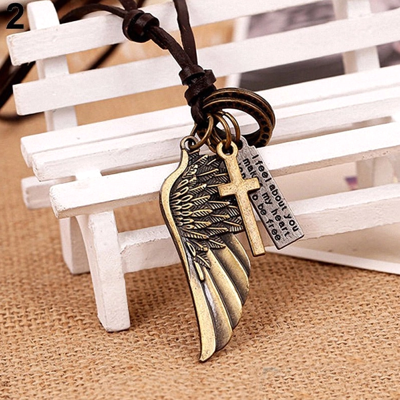 Brown leather gothic necklace with bronze-toned angel wing and charm pendants, flat lay top-down view