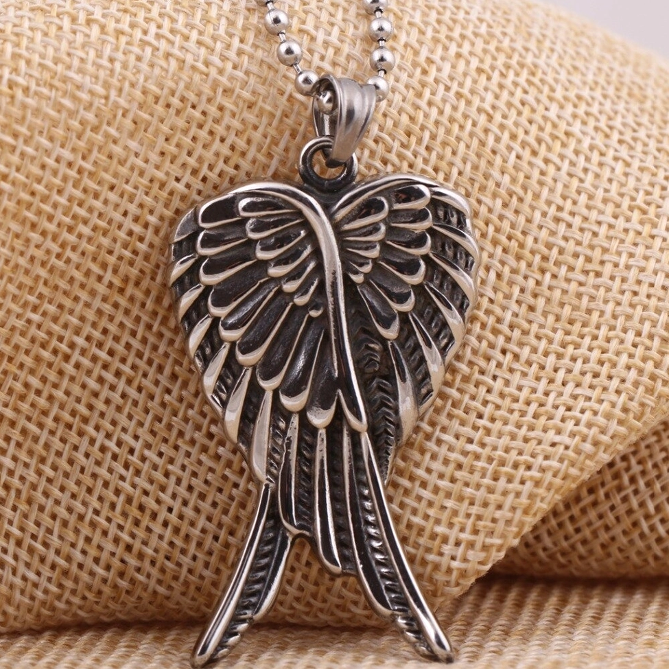 Gothic Angel Wings Pendant Necklace on Linen Background - Three-Quarter Front Angle Showing Antique Silver Stainless Steel