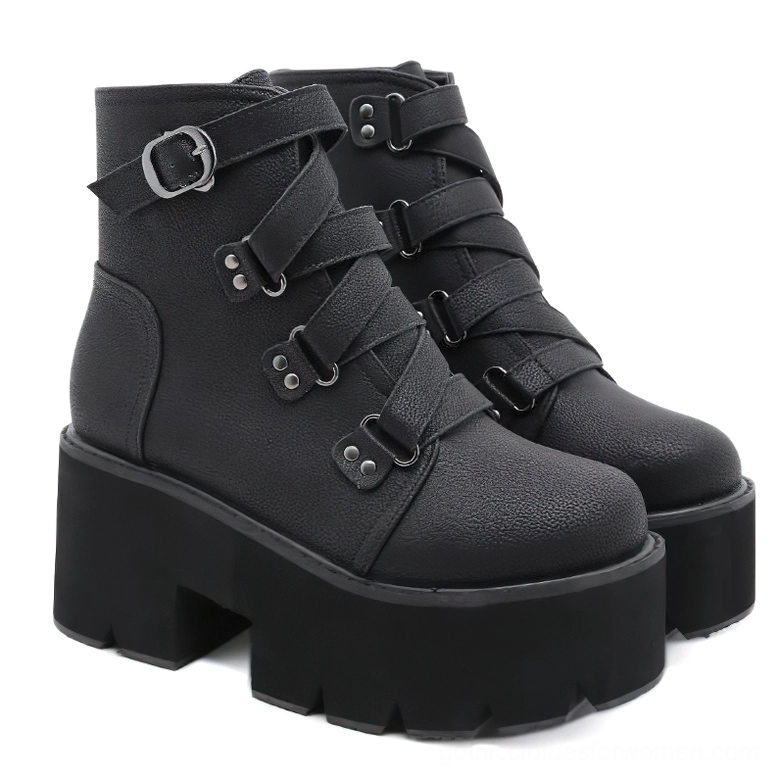 Pair of black gothic platform ankle boots rear view displaying chunky lugged rubber sole and buckle decoration