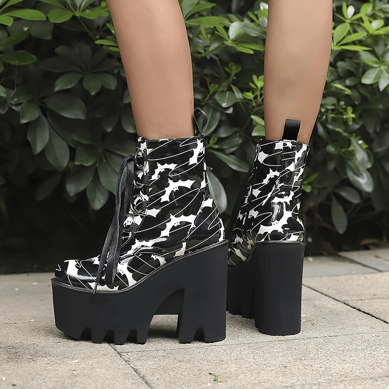 Gothic platform ankle boots with bat print pattern, side detail view showing the round toe silhouette and robust rubber outsole construction