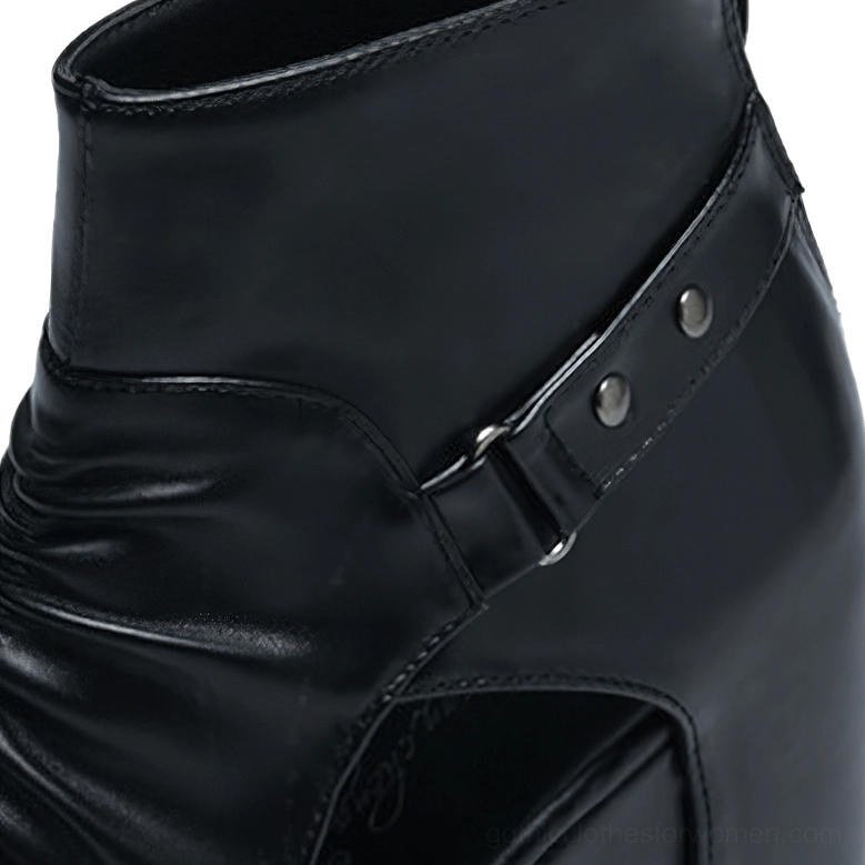 Close-up of gothic ankle boots studded metal buckle strap and ruched leather detail