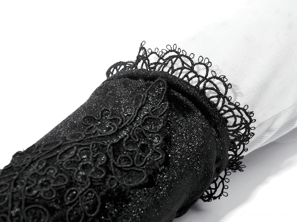 Extreme close-up of gothic arm warmer cuff showing intricate scalloped lace trim and glittery velvet fabric