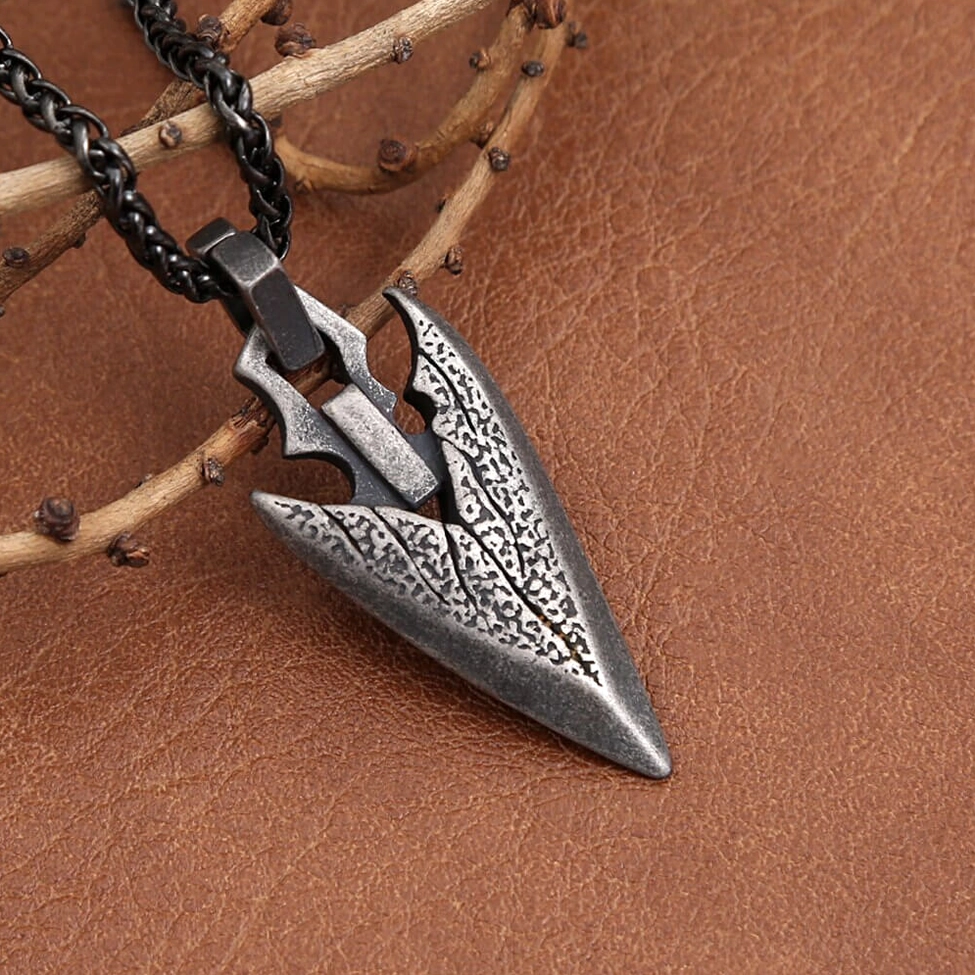 Side oblique view dark silver arrowhead gothic pendant - leather and wood aesthetic styling