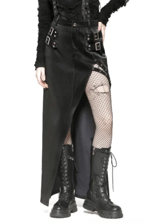 Black asymmetrical PU leather gothic skirt with metal buckles worn by model, front three-quarter view showing high-waisted cut and dramatic side slit