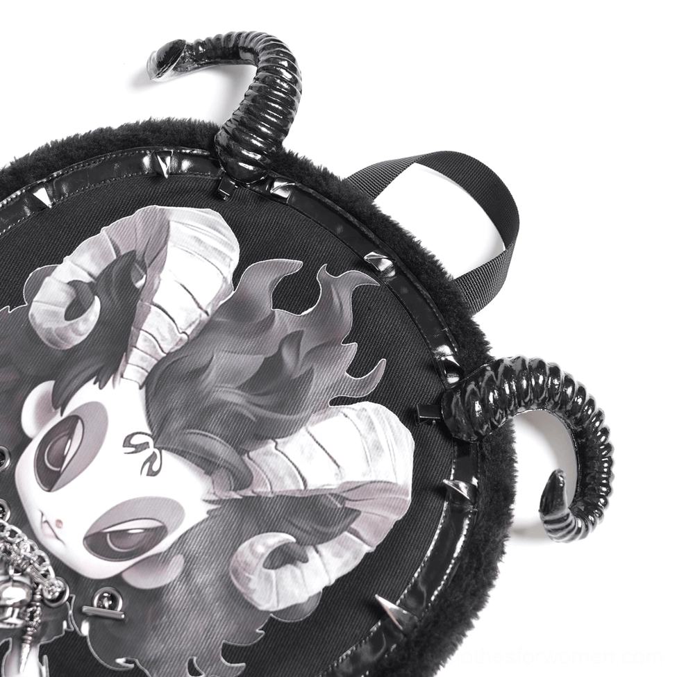 Low angle close-up of backpack corner highlighting metal spiral horns, spike trim details, and demon face print