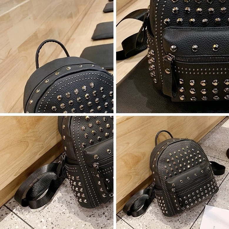 Close-up top view of gothic backpack showing leather top handle and silver rivet trim details