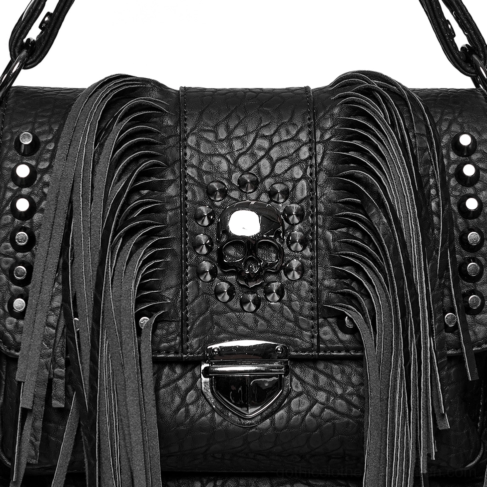Skull tassel bag close-up showing pebbled leather texture, studded skull trim, fringe, and metal lock