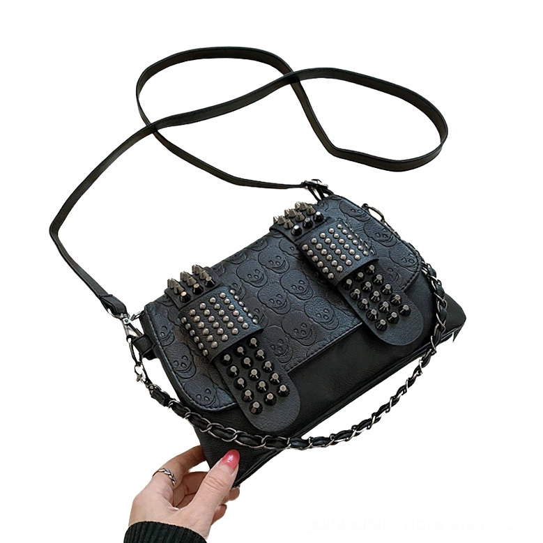 Low angle view of gothic rivet crossbody bag - highlighting embossed details and dual carrying capability