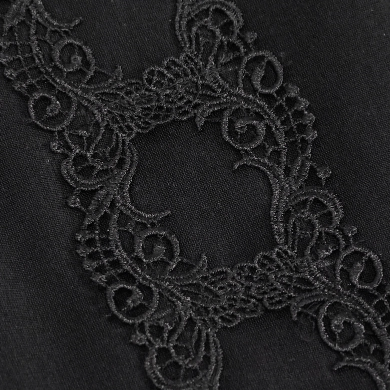 Detailed shot of swirl floral guipure lace pattern trim on black gothic bucket bag