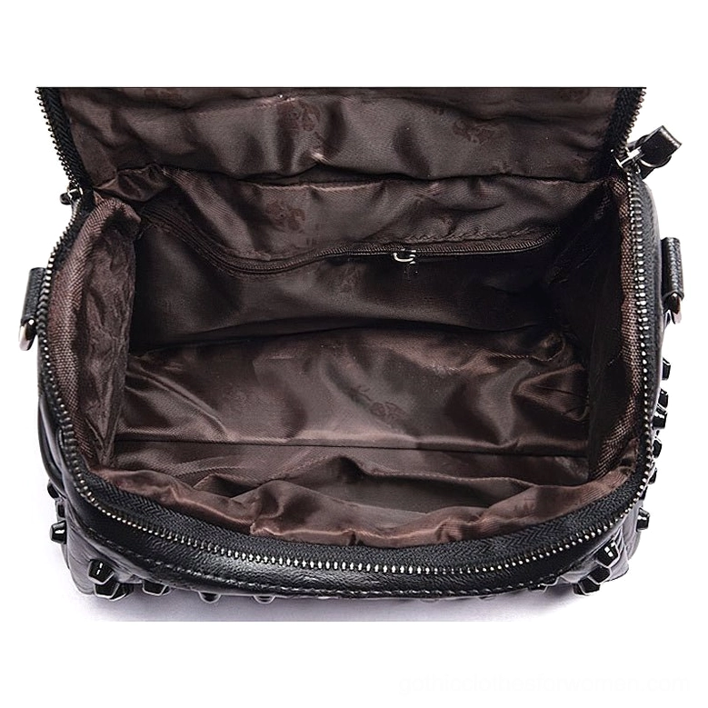 Interior view of black sheepskin leather messenger bag showing satin polyester lining, internal zipper pocket, and riveted base construction