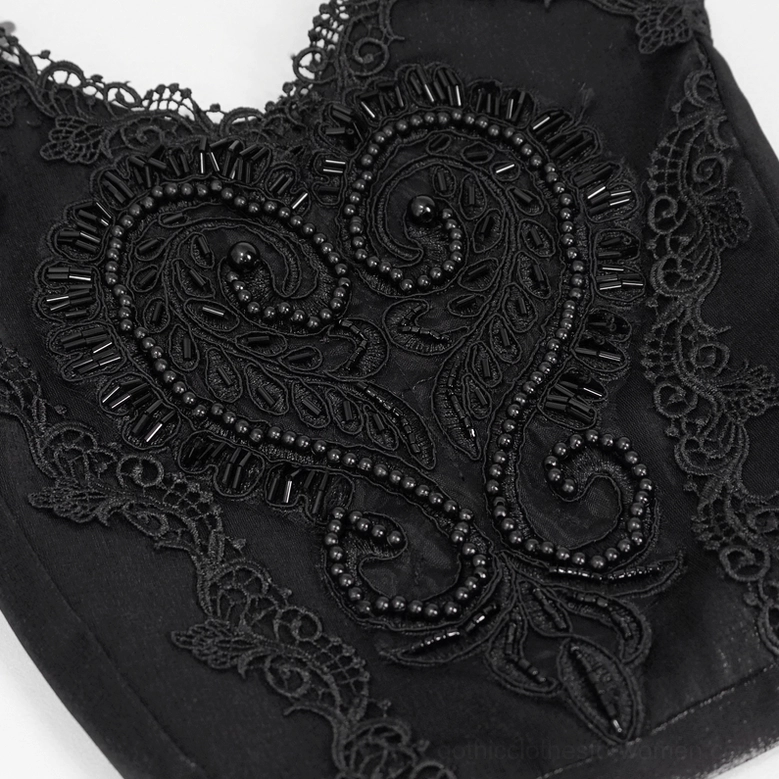 Macro close-up of beaded paisley heart guipure lace embroidery detail on black gothic bag
