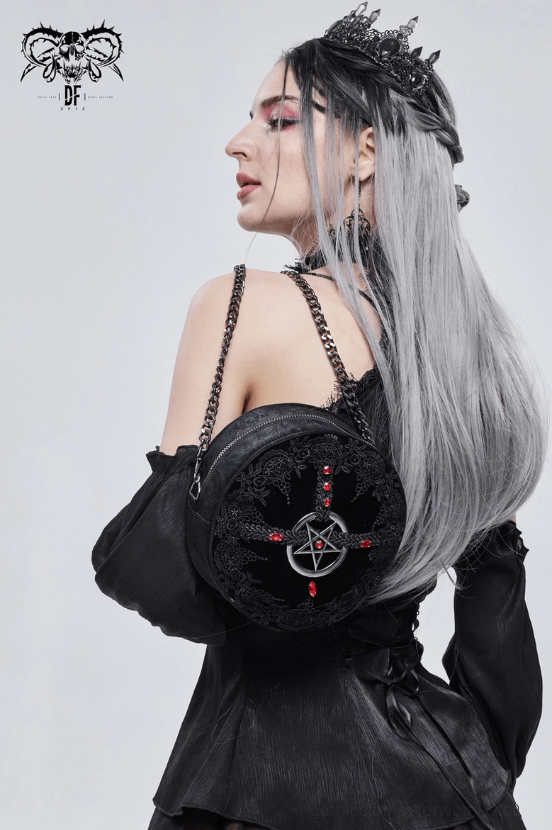 Detailed view of gothic round bag pentagram charm and lace panel arrangement showing design composition
