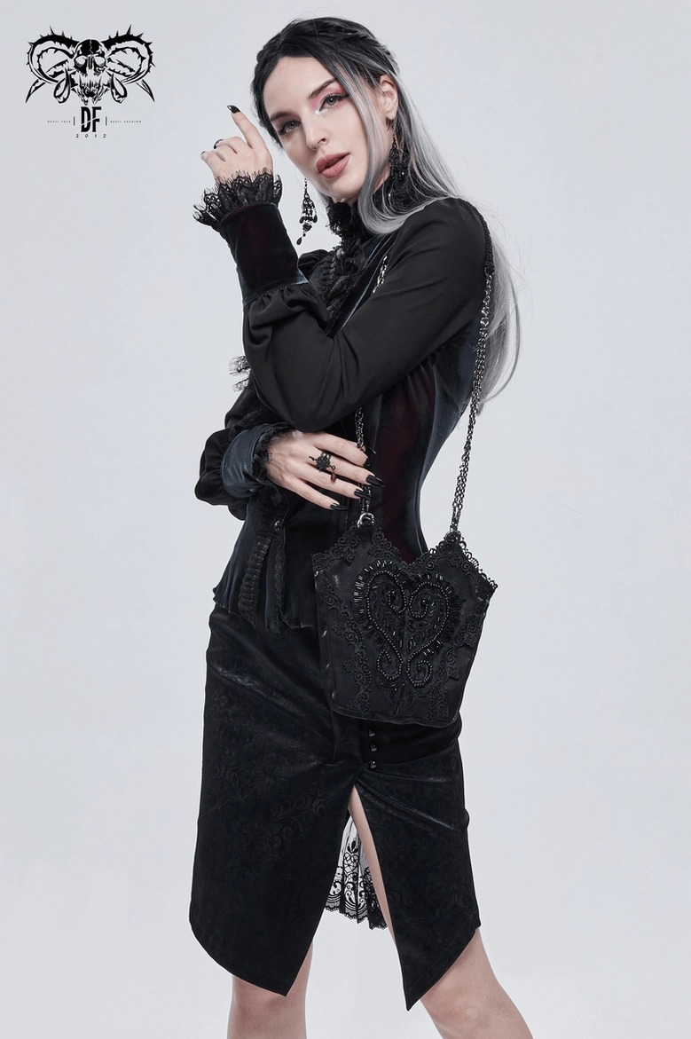 Side three-quarter view of black gothic bucket bag styled with black fitted outfit