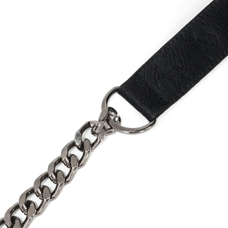 Close-up detail of gothic bag strap set including fabric strap, silver curb chain link, and metal D-ring connectors
