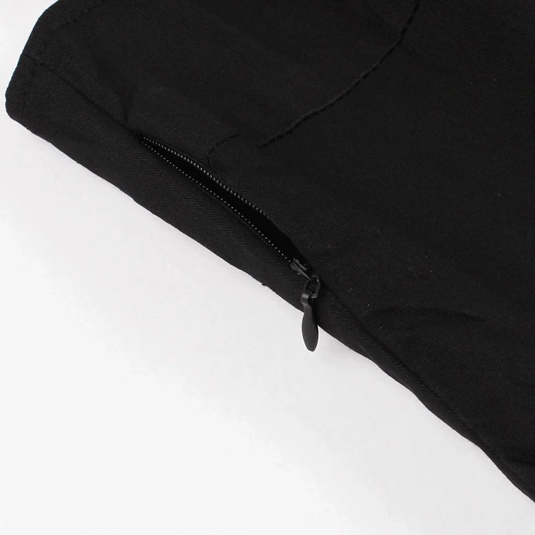 Angled close-up of white bat and branch embroidery design on side of black gothic dress with artistic detail