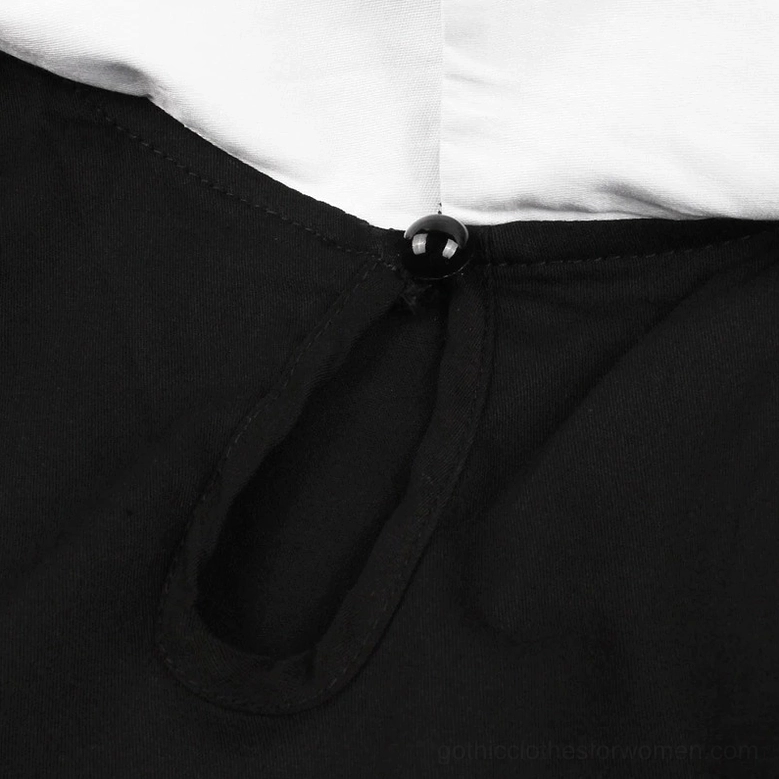 White embroidered bat motifs on black fabric close-up showing intricate embroidery craftsmanship and thread detail