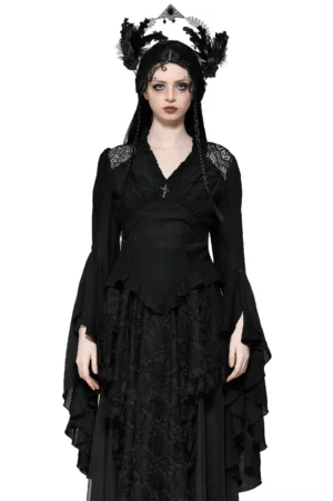 Black Victorian bell sleeve gothic blouse with lace shoulder panels and silver cross brooch, front full-body view on model
