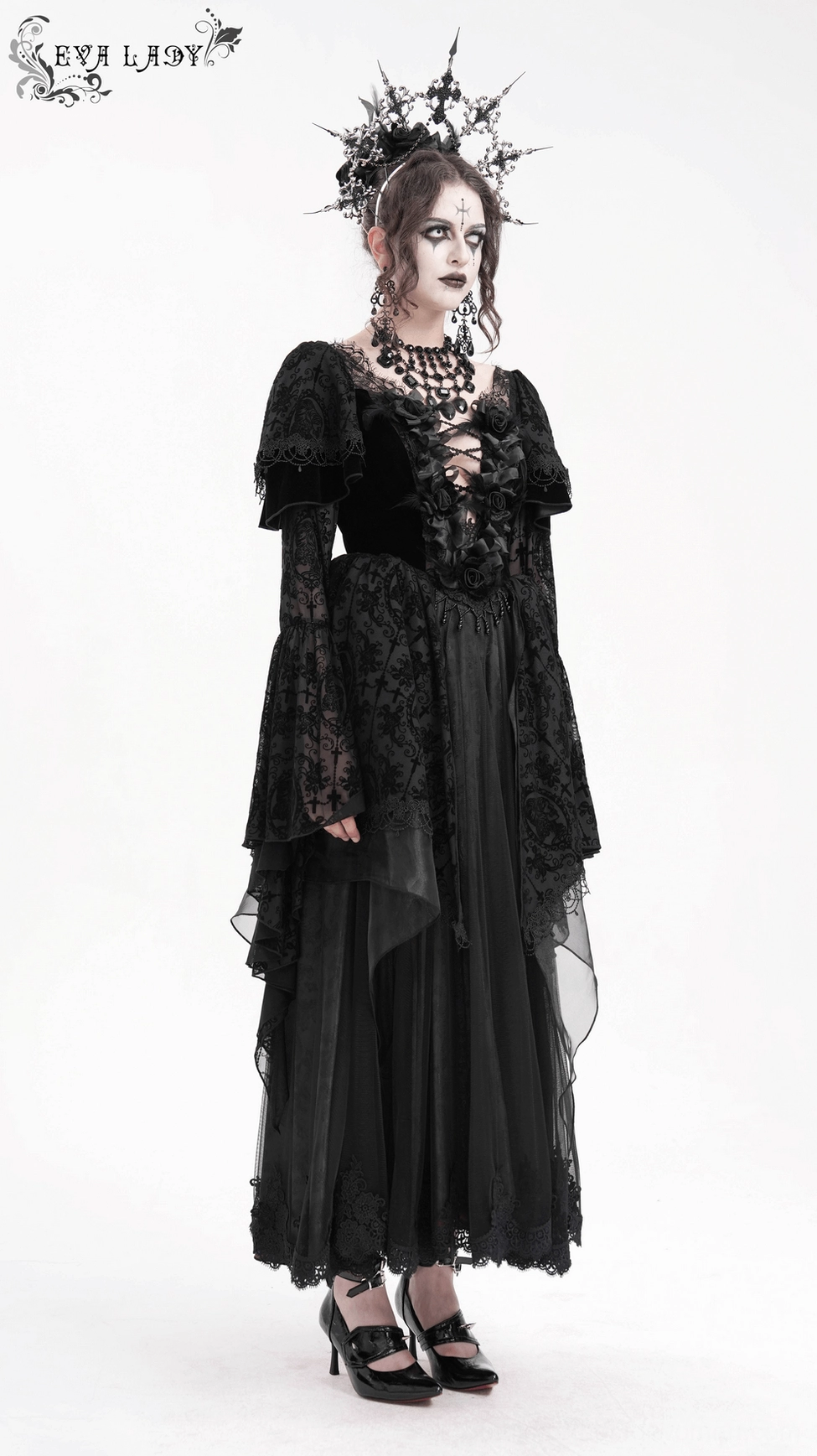 Black gothic dress full-length product image highlighting bell sleeves, asymmetrical hemline, and ornate lace overlay details