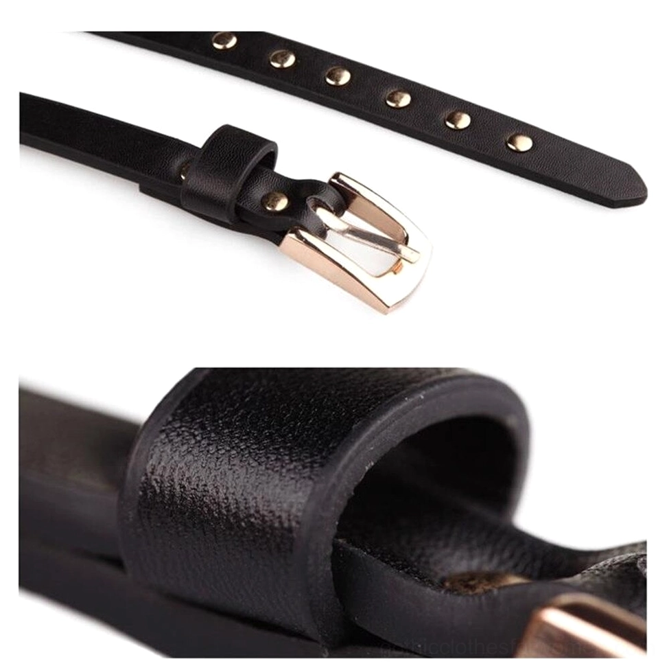Close-up detail of black thin belt buckle and rivet strap, side flat lay showing gold metal pin buckle and leather embellishment