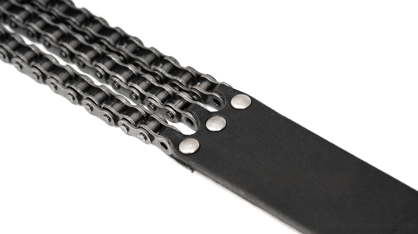 Top-down close-up of heavy-duty triple-row motorcycle chain strap with metal rivets on black leather and dark silver finish