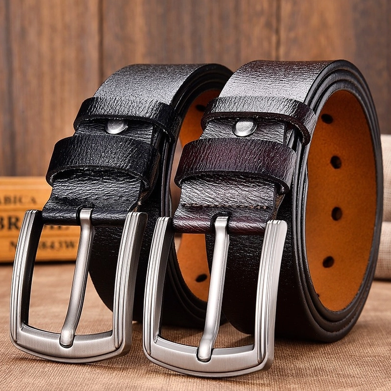 Black and dark brown gothic leather belts displayed together on wooden surface, showing both color options with matching metal buckles
