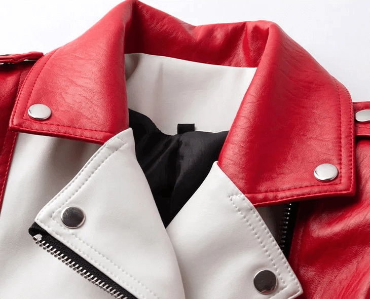 Close-up detail of gothic biker jacket lapel collar with metal snap buttons and contrasting red-white faux leather design