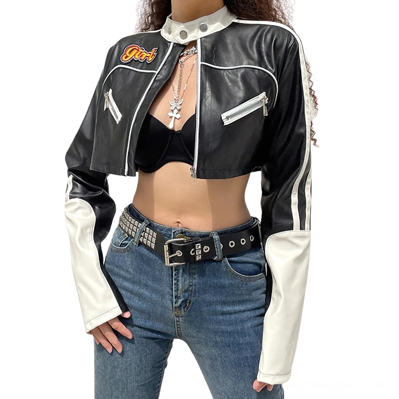 Front view of black and white cropped leather biker jacket with zipper chest pockets and short hemline, worn by model
