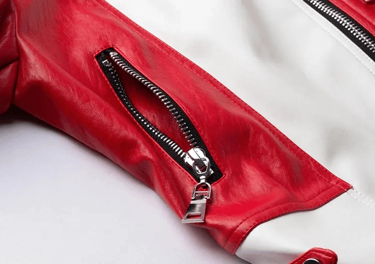 Side zipper pocket detail of red and white gothic biker jacket with metal hardware and faux leather