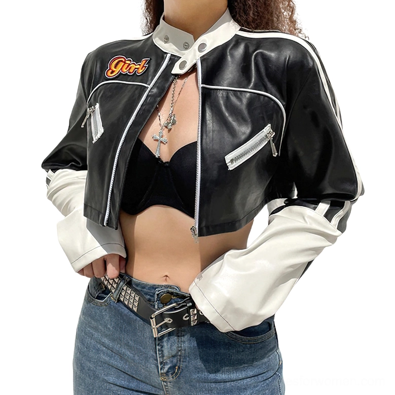 Side front view of black and white gothic cropped biker jacket on model styled with cross necklace and denim
