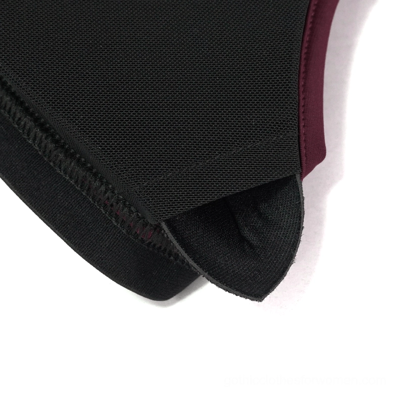 Close-up flat lay of burgundy gothic bikini fabric binding showing smooth stretch material and edge trim